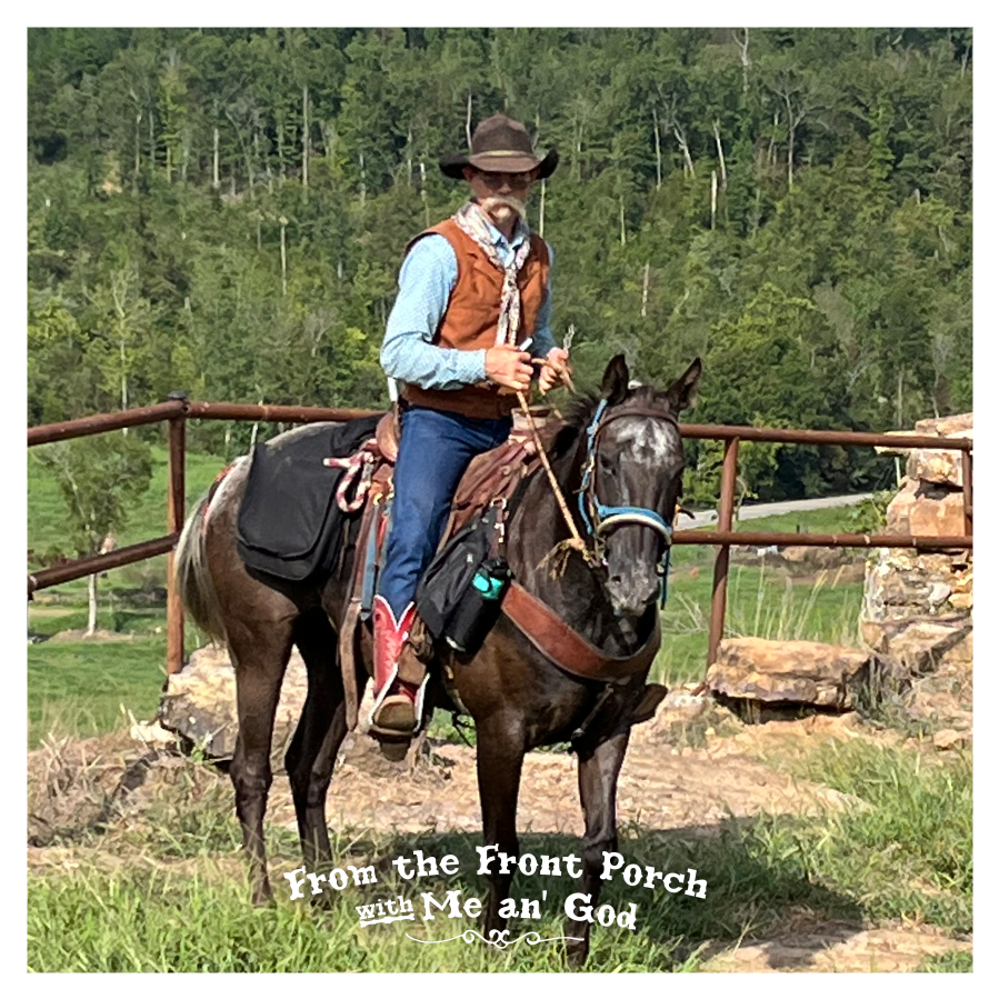 A cowboy poet rids atop a black horse on a ranch near a fence. A text overlay on the image says "From the Front Porch with Me an' God".