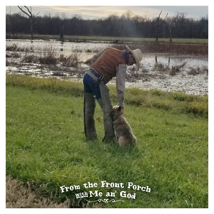 Loren Dean leaning to pet man's best friend. A text overlay on the image says "From the Front Porch with Me an' God".